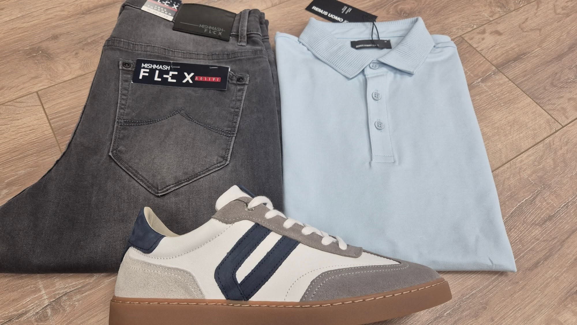 Grey jeans, a light-blue polo and a casual trainer on the menswear floor