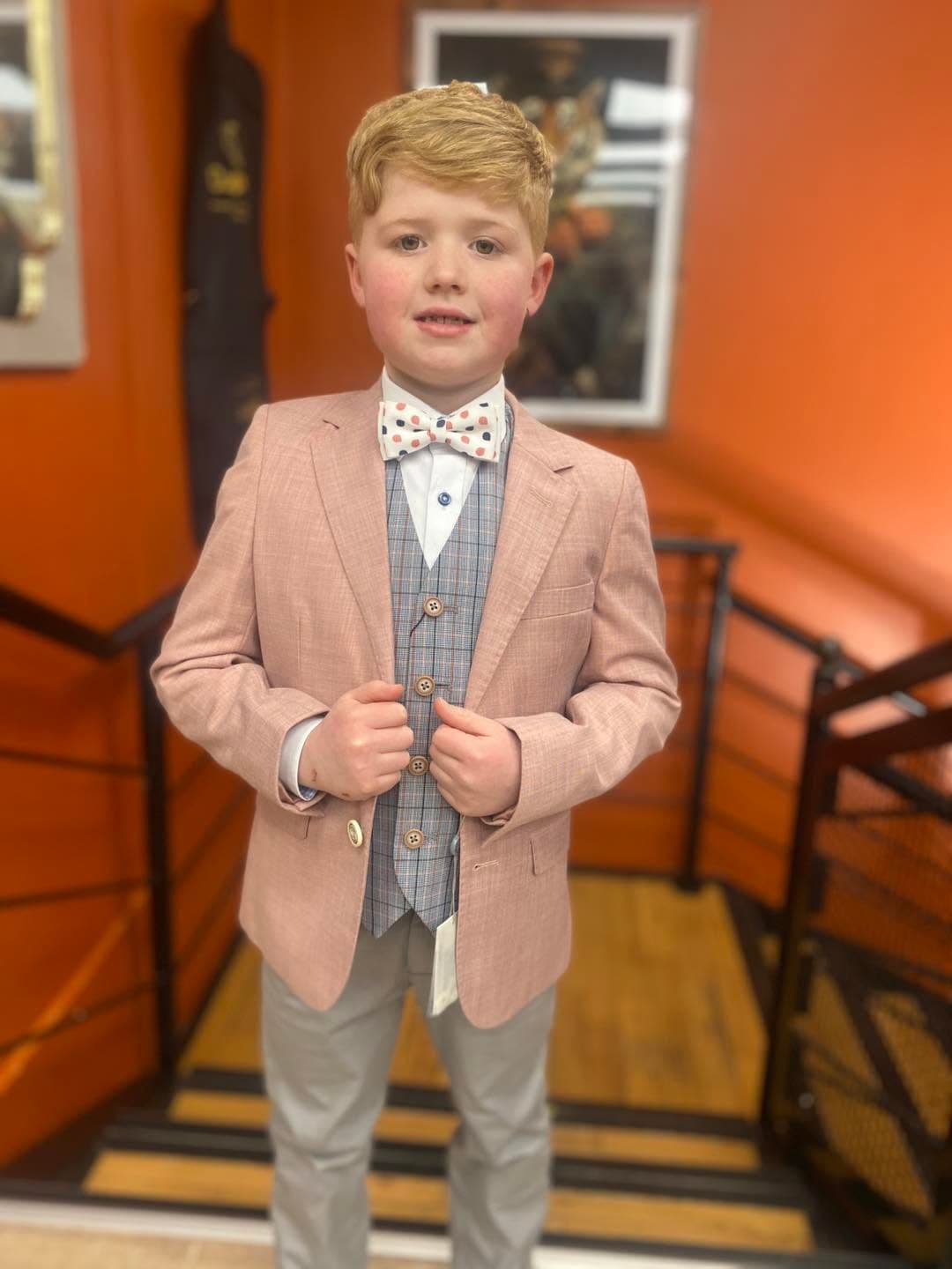 A dusty-pink communion jacket and checked waistcoat, fitted at Dapper