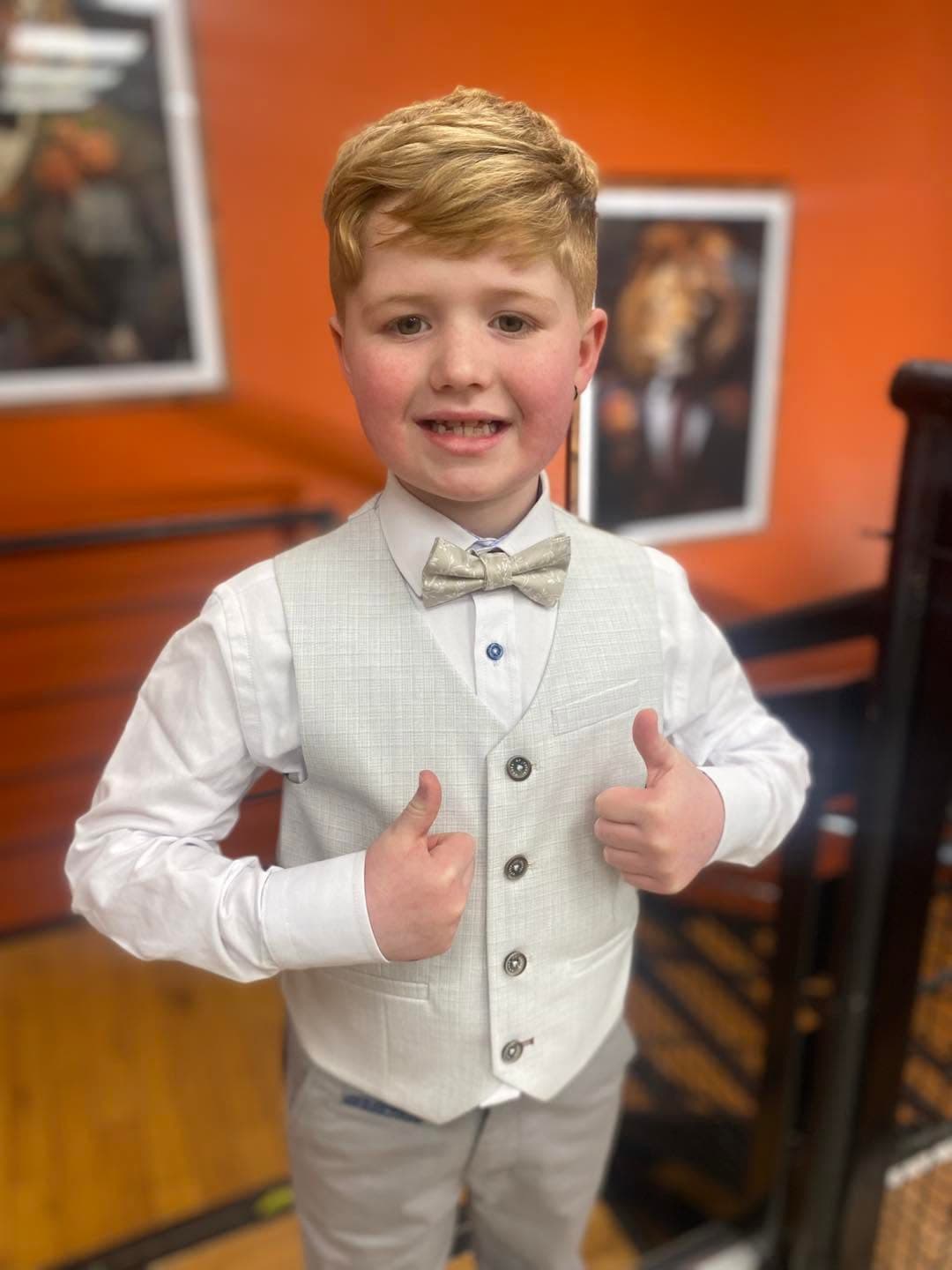 A pale communion waistcoat and bow tie, fitted at Dapper