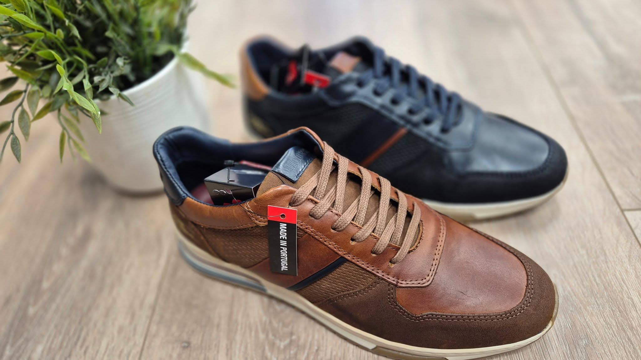 Tan and navy leather trainers on the shop floor