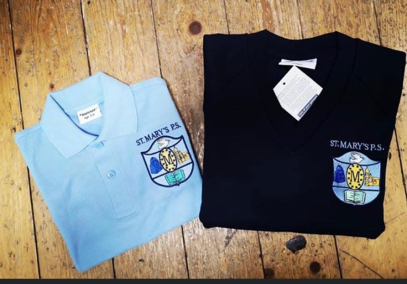 Light-blue St Mary’s polo and a navy crested jumper